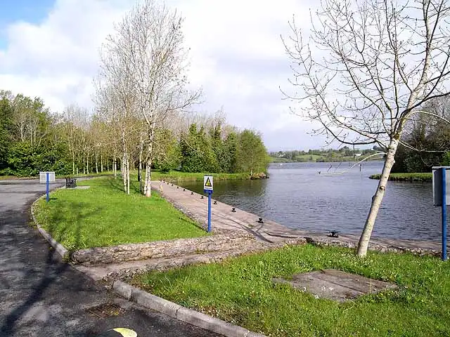 The stone-edged quay at Haughton’s Shore on Garadice Lough, with lawns, young trees and the open lake beyond.