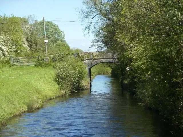 A small stone road bridge crosses the Lough Allen Canal between green banks near Drumleague Lock.